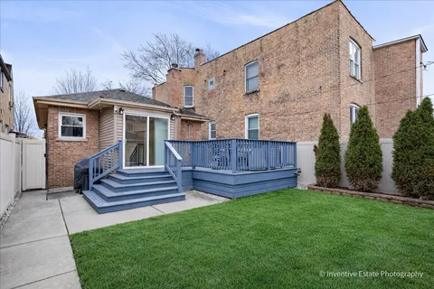 a view of a house with a yard and sitting area