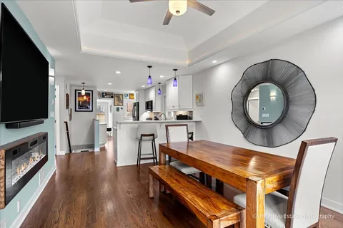 a living room with furniture a flat screen tv and kitchen view