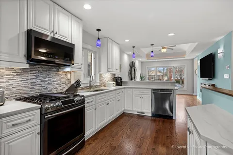 a kitchen with a sink stove and microwave