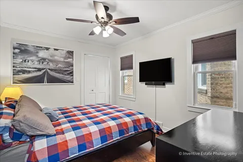 a bedroom with a bed window tv and couch