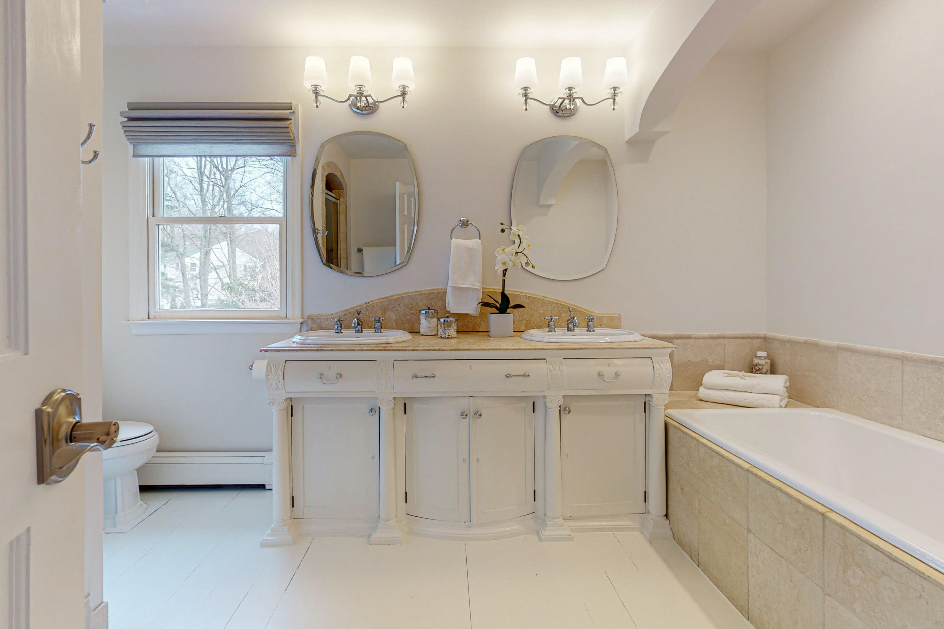 16 Barringer Road Darien, CT 06820 - Photo 29 of 43 a bathroom with a double vanity sink and a mirror