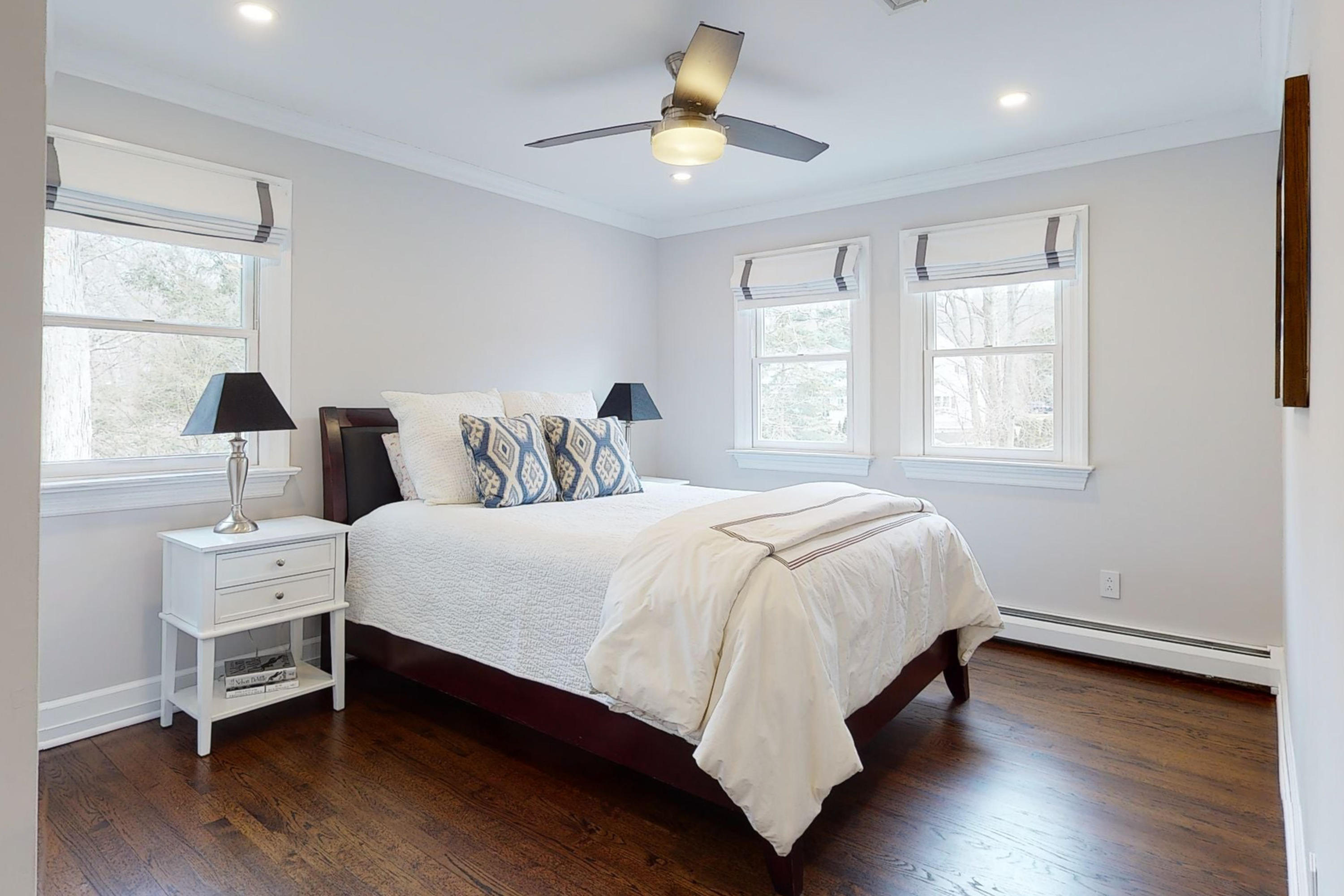 16 Barringer Road Darien, CT 06820 - Photo 35 of 43 a bedroom with a bed and a chandelier