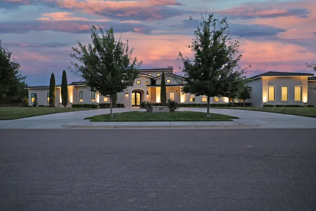 a front view of house with yard and green space