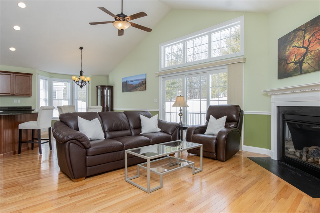 43 Old Mill Circle Westminster, MA 01473 - Photo 15 of 30 a living room with furniture a fireplace and a flat screen tv