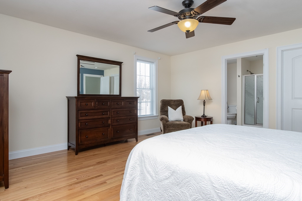 43 Old Mill Circle Westminster, MA 01473 - Photo 18 of 30 a bedroom with a bed and a chandelier