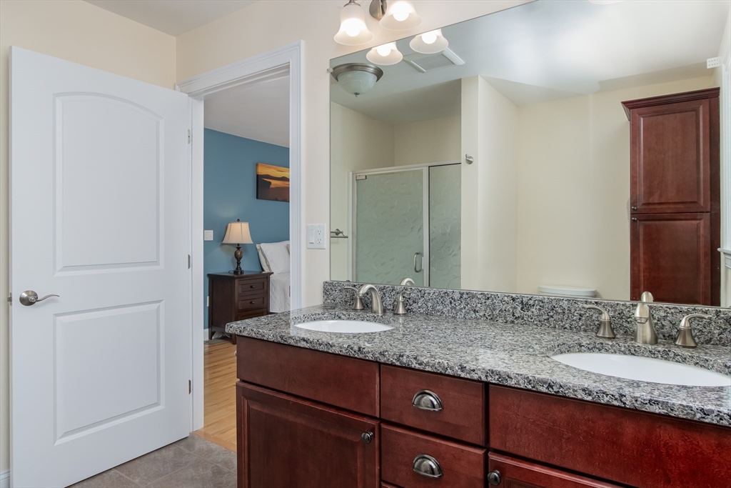 43 Old Mill Circle Westminster, MA 01473 - Photo 20 of 30 a bathroom with a granite countertop sink and a mirror