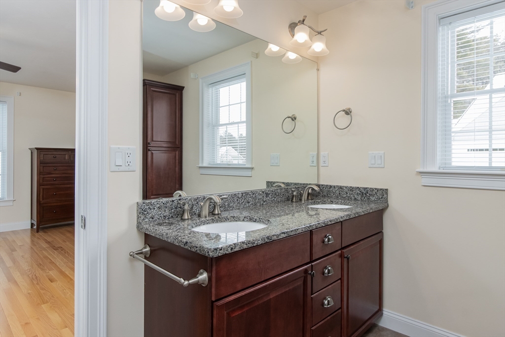 43 Old Mill Circle Westminster, MA 01473 - Photo 22 of 30 a bathroom with a granite countertop sink a light fixture and a mirror