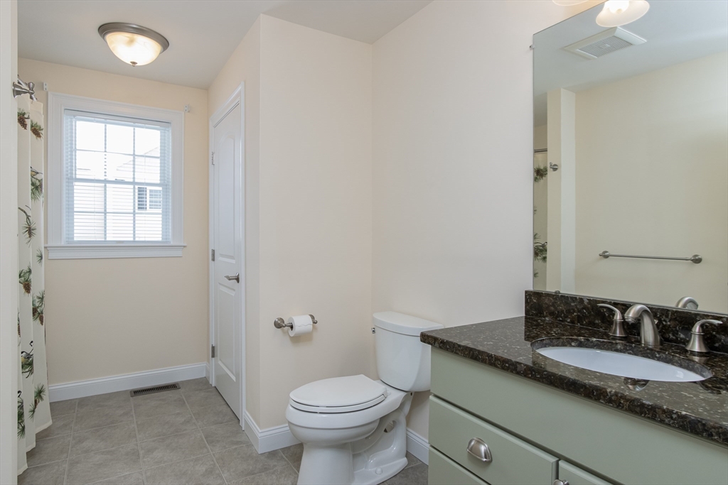 43 Old Mill Circle Westminster, MA 01473 - Photo 24 of 30 a bathroom with a granite countertop sink a toilet and a window