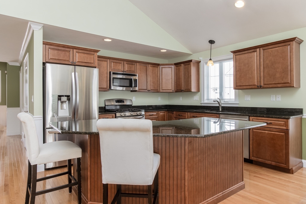 43 Old Mill Circle Westminster, MA 01473 - Photo 5 of 30 a kitchen with stainless steel appliances granite countertop a refrigerator a stove a sink a dining table and chairs