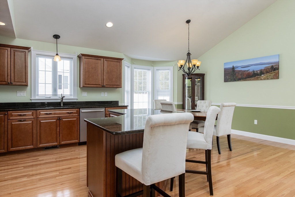 43 Old Mill Circle Westminster, MA 01473 - Photo 6 of 30 a kitchen with a kitchen island hardwood floor sink stove dining table and chairs