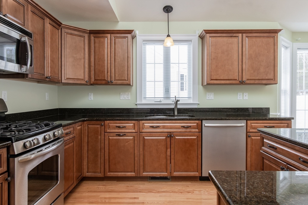 43 Old Mill Circle Westminster, MA 01473 - Photo 7 of 30 a kitchen with stainless steel appliances granite countertop a stove a sink and a microwave