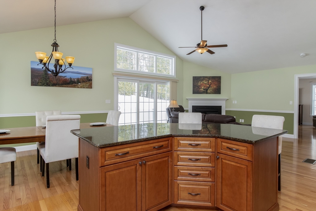 43 Old Mill Circle Westminster, MA 01473 - Photo 8 of 30 a kitchen with granite countertop cabinets a dining table and a chandelier