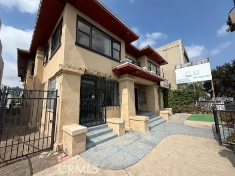 a view of a building with floor to ceiling windows and a rug