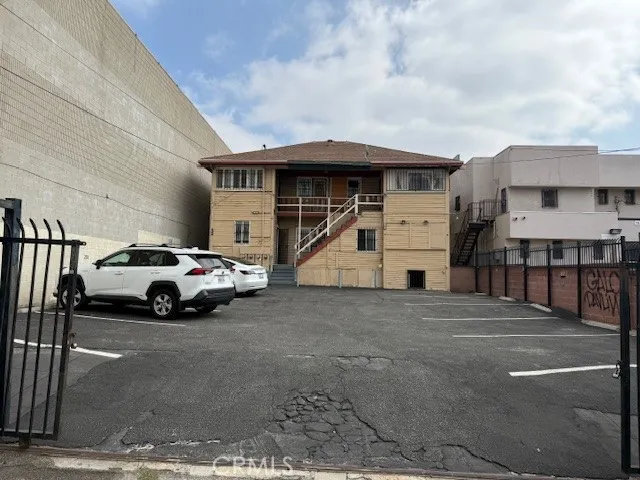 a view of building with car parked