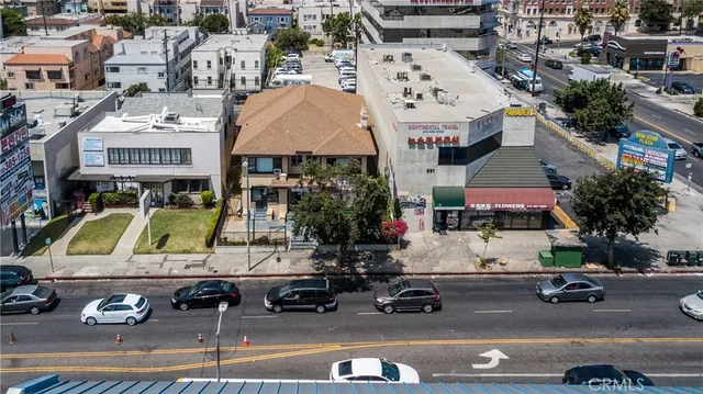 an aerial view of a building with parked cars