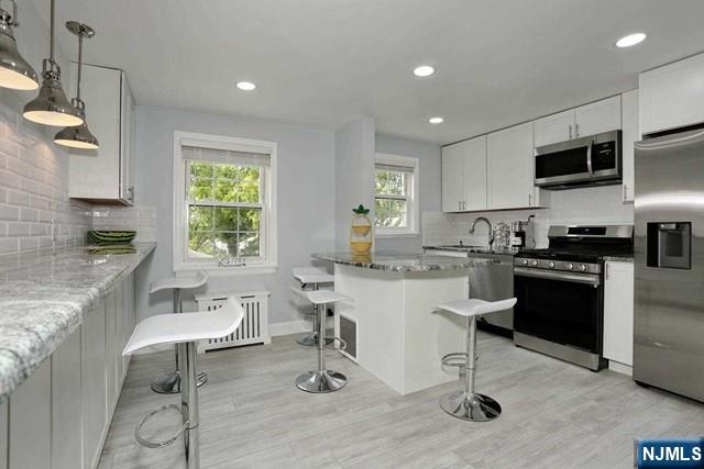 100 Huguenot Avenue, Unit 6B Englewood, NJ 07631 - Photo 1 of 24 a kitchen with a sink cabinets and window