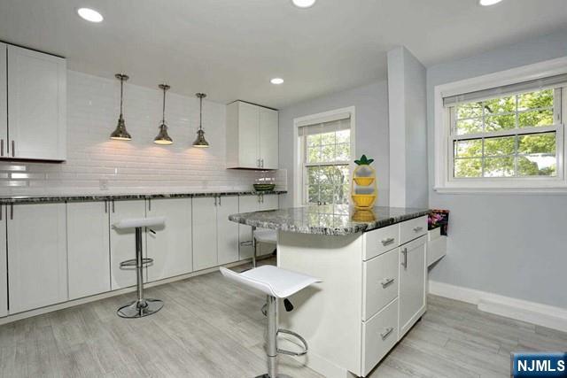 100 Huguenot Avenue, Unit 6B Englewood, NJ 07631 - Photo 12 of 24 a kitchen with granite countertop a stove a sink and a refrigerator