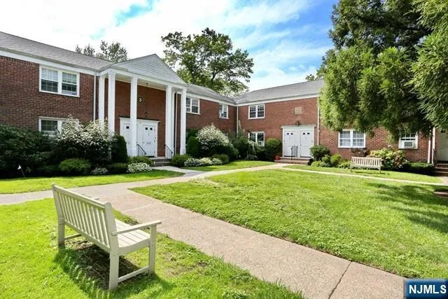 a front view of house and yard with trees