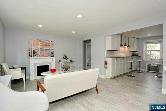 100 Huguenot Avenue, Unit 6B Englewood, NJ 07631 - Photo 3 of 24 a living room with furniture and a fireplace