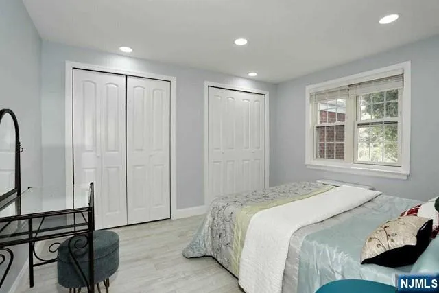 a bedroom with a bed a dresser and a window