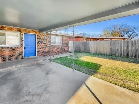 a view of a backyard with wooden fence