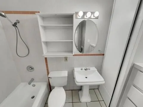 a bathroom with a toilet sink and shower