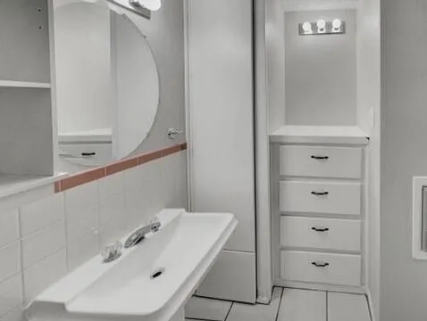 a bathroom with a sink and mirror