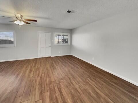 2107 35th Street, Unit B Lubbock, TX 79412 - Photo 2 of 18 a view of empty room with wooden floor