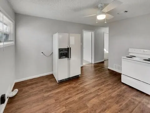 a view of a kitchen with wooden floor