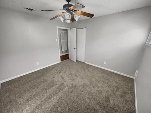 2107 35th Street, Unit B Lubbock, TX 79412 - Photo 9 of 18 en empty room with windows and fan