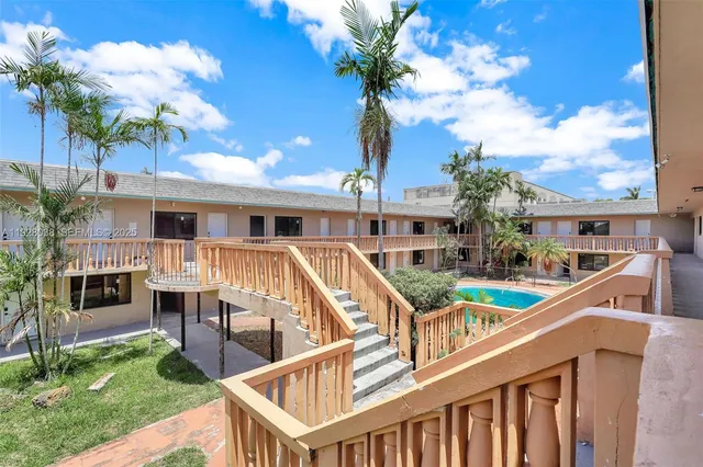 a balcony with table and chairs