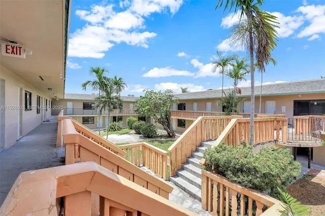 a view of house with staircase and palm trees
