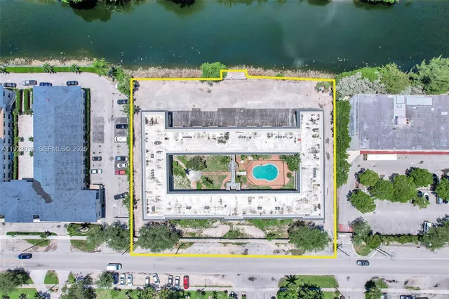 an aerial view of a house with a garden and swimming pool