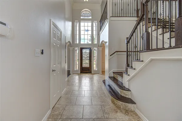 a view of entryway and hall with wooden floor