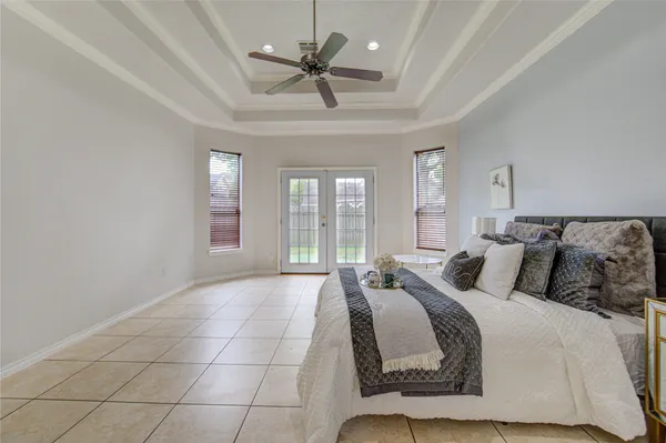 a bedroom with a large bed and a large window