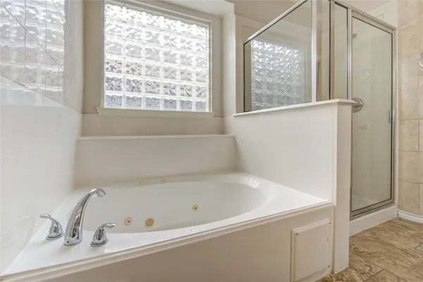 a bathroom with a bathtub and a window