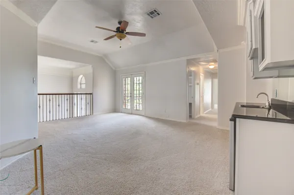 a view of a livingroom with a ceiling fan and window