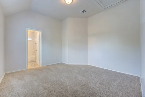 a view of an empty room and a window