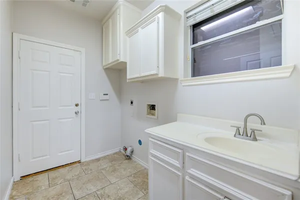 a bathroom with a sink and cabinets
