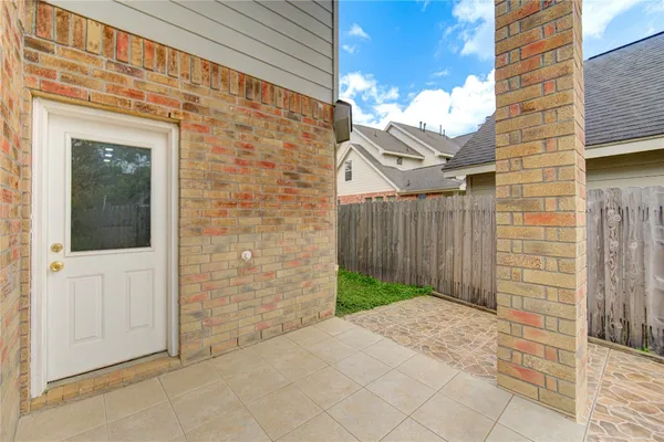 a view of a brick house with a yard
