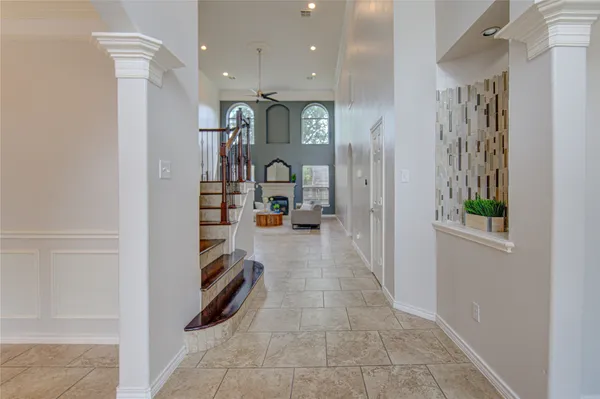 a view of hallway with stairs and furniture