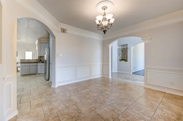 a view of a hallway with chandelier and livingroom