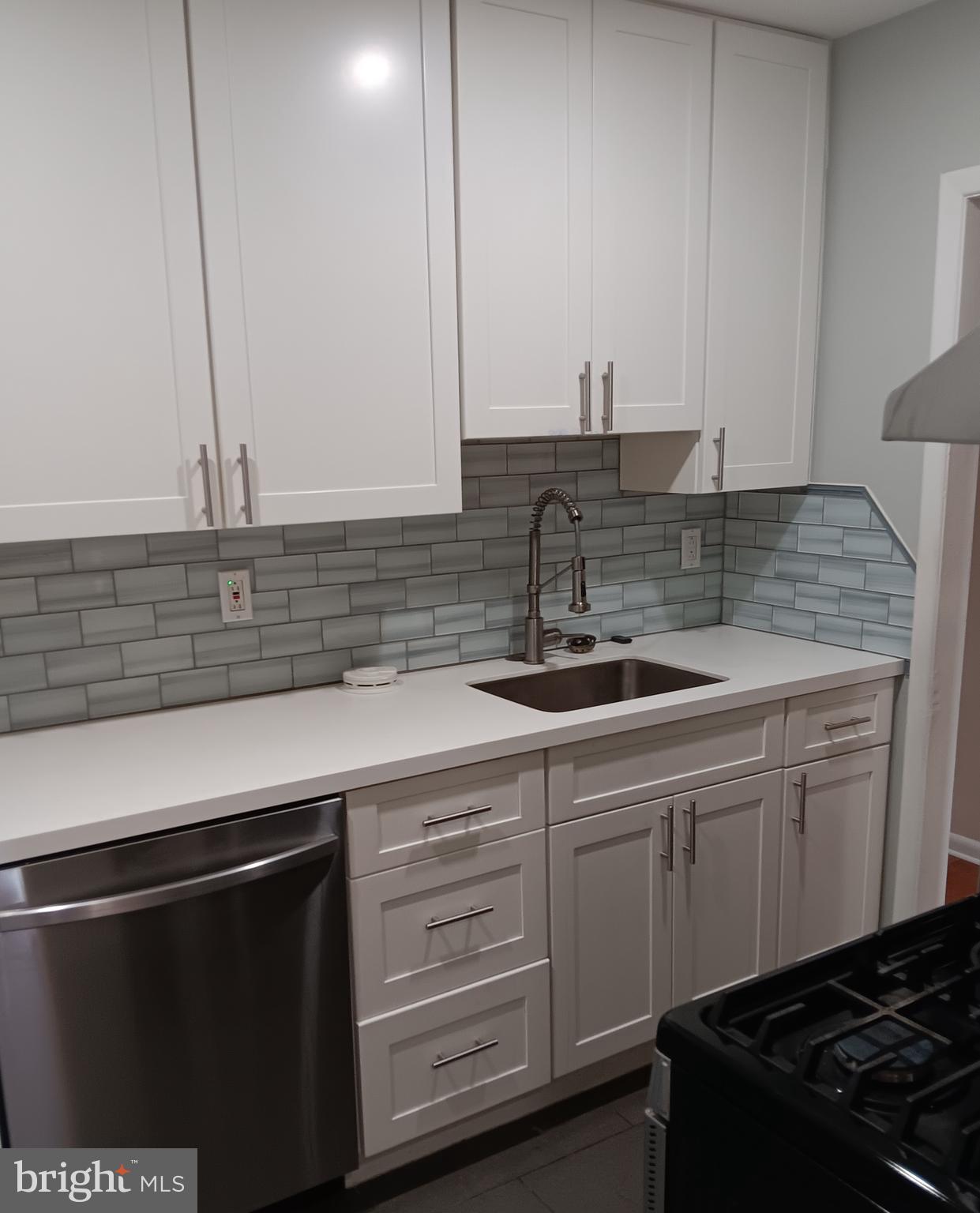 153 Burmont Road, Unit B Drexel Hill, PA 19026 - Photo 5 of 19 a kitchen with stainless steel appliances granite countertop a sink stove and cabinets