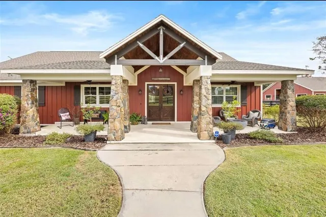 a view of a house with swimming pool and furniture