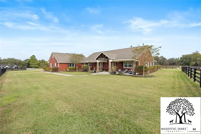a kitchen with stainless steel appliances kitchen island granite countertop a table and chairs in it