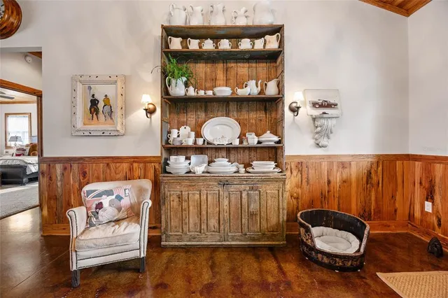 a bedroom with a bed and a flat tv screen on the dresser