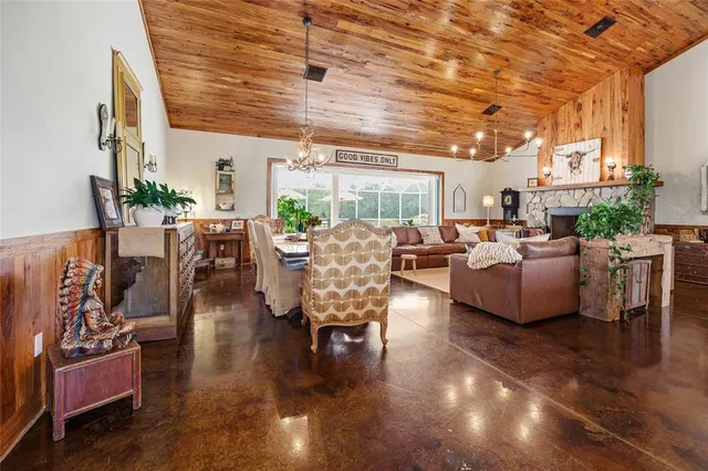 a room with lots of wooden furniture and a window