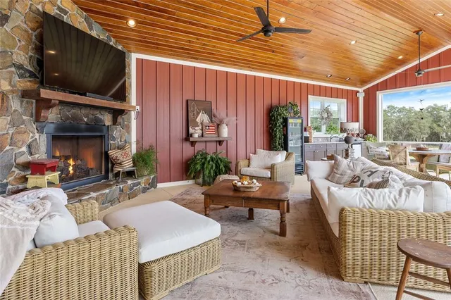 a view of swimming pool with lawn chairs and iron fence