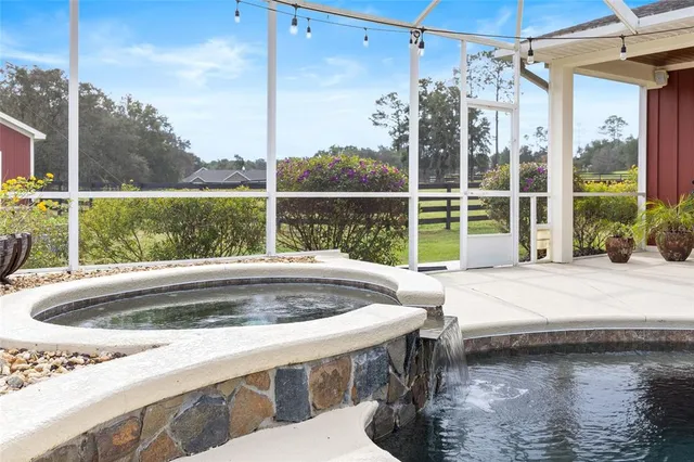 a dining room with furniture and a floor to ceiling window