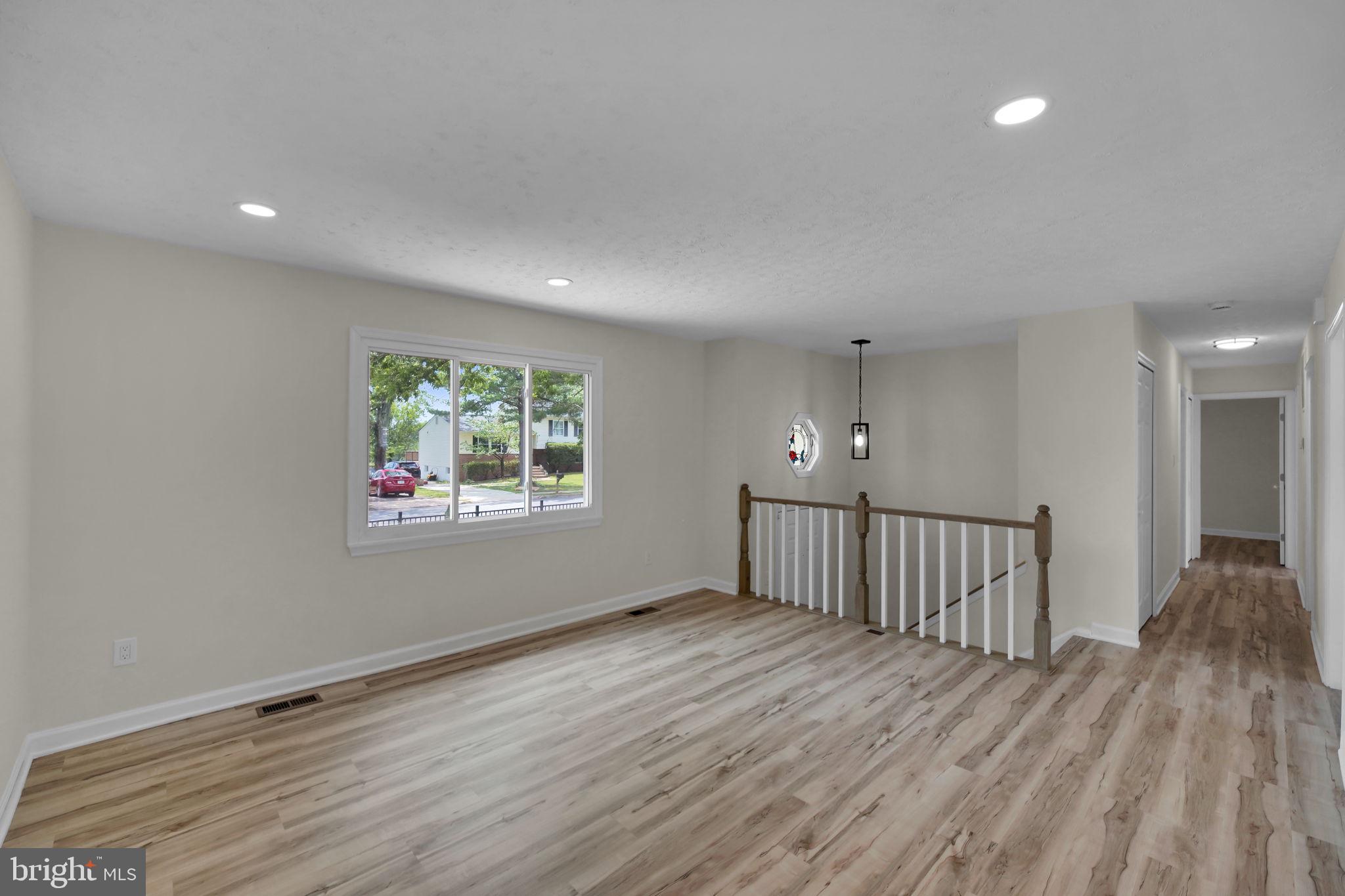 8613 Weems Road Manassas, VA 20110 - Photo 3 of 50 a view of an empty room with wooden floor and a window